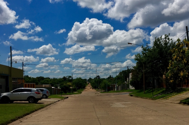 Paved road turns to dirt in the distance
