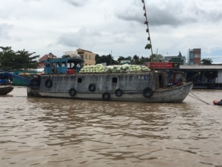 A boat selling cabbage among other vegetables